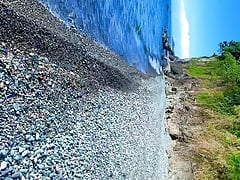 Guy jerking off dick on a nudist beach and a passerby joined him